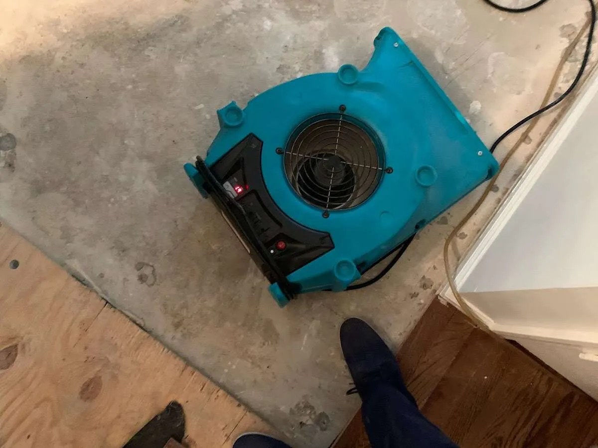 Air mover drying subfloor during Leak Detection & Repair in Buckhall